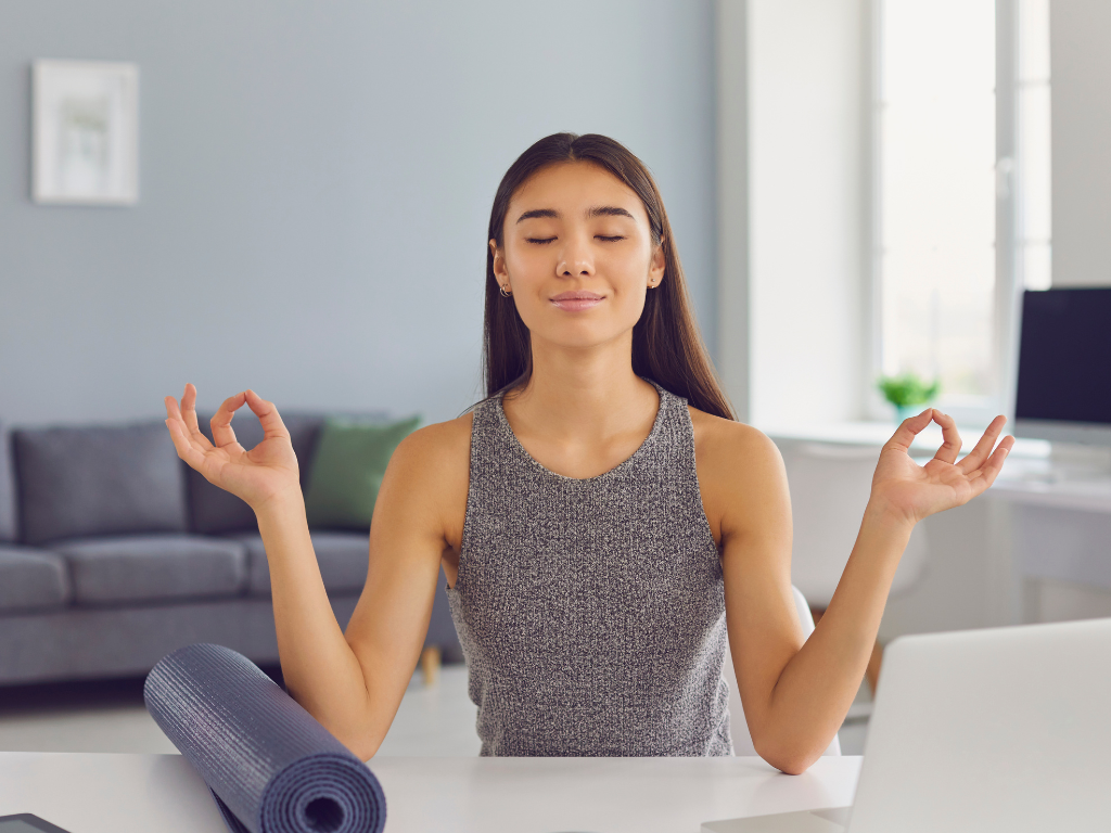 Harmonic woman meditating at her desk